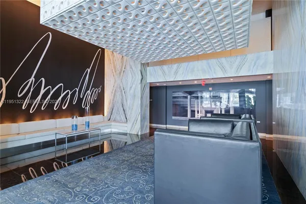 a living room with fireplace furniture and a rug