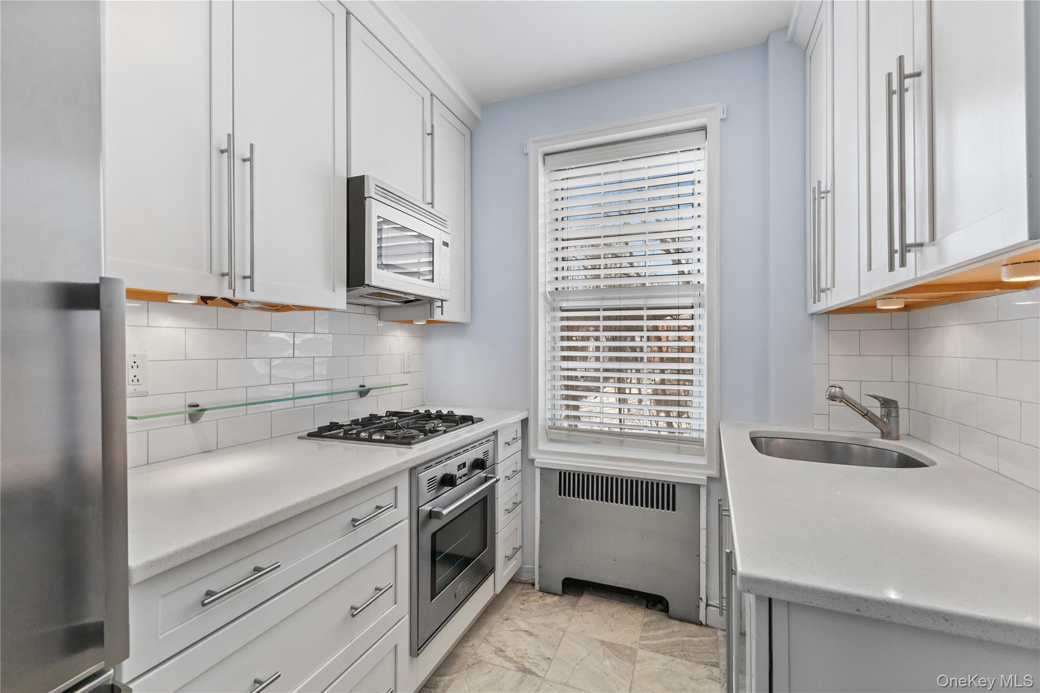 74 Pinewood Road, Unit 2F Hartsdale, NY 10530 - Photo 11 of 29 a kitchen with granite countertop a sink stove and cabinets