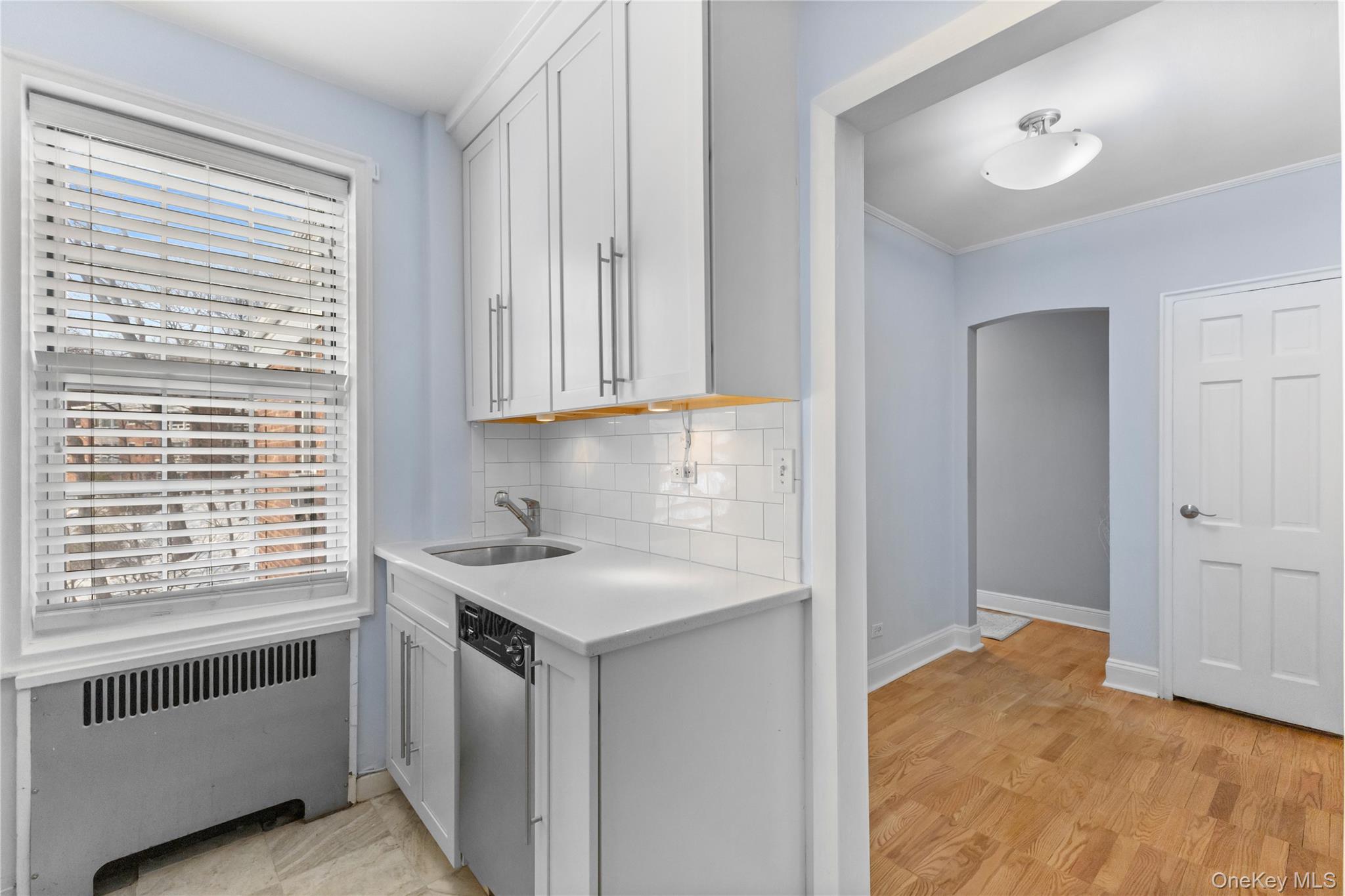 74 Pinewood Road, Unit 2F Hartsdale, NY 10530 - Photo 12 of 29 a view of a kitchen with a sink dishwasher and fireplace