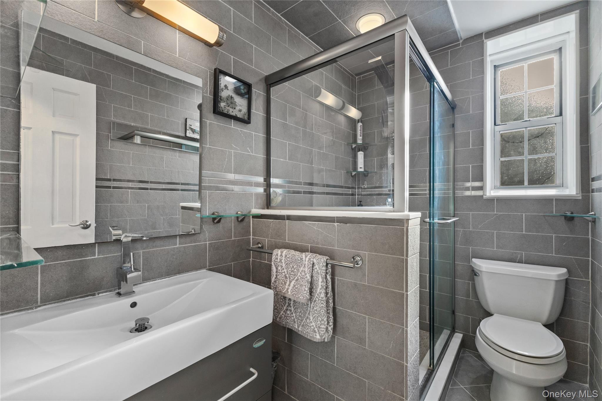 74 Pinewood Road, Unit 2F Hartsdale, NY 10530 - Photo 20 of 29 a bathroom with a sink a toilet and shower