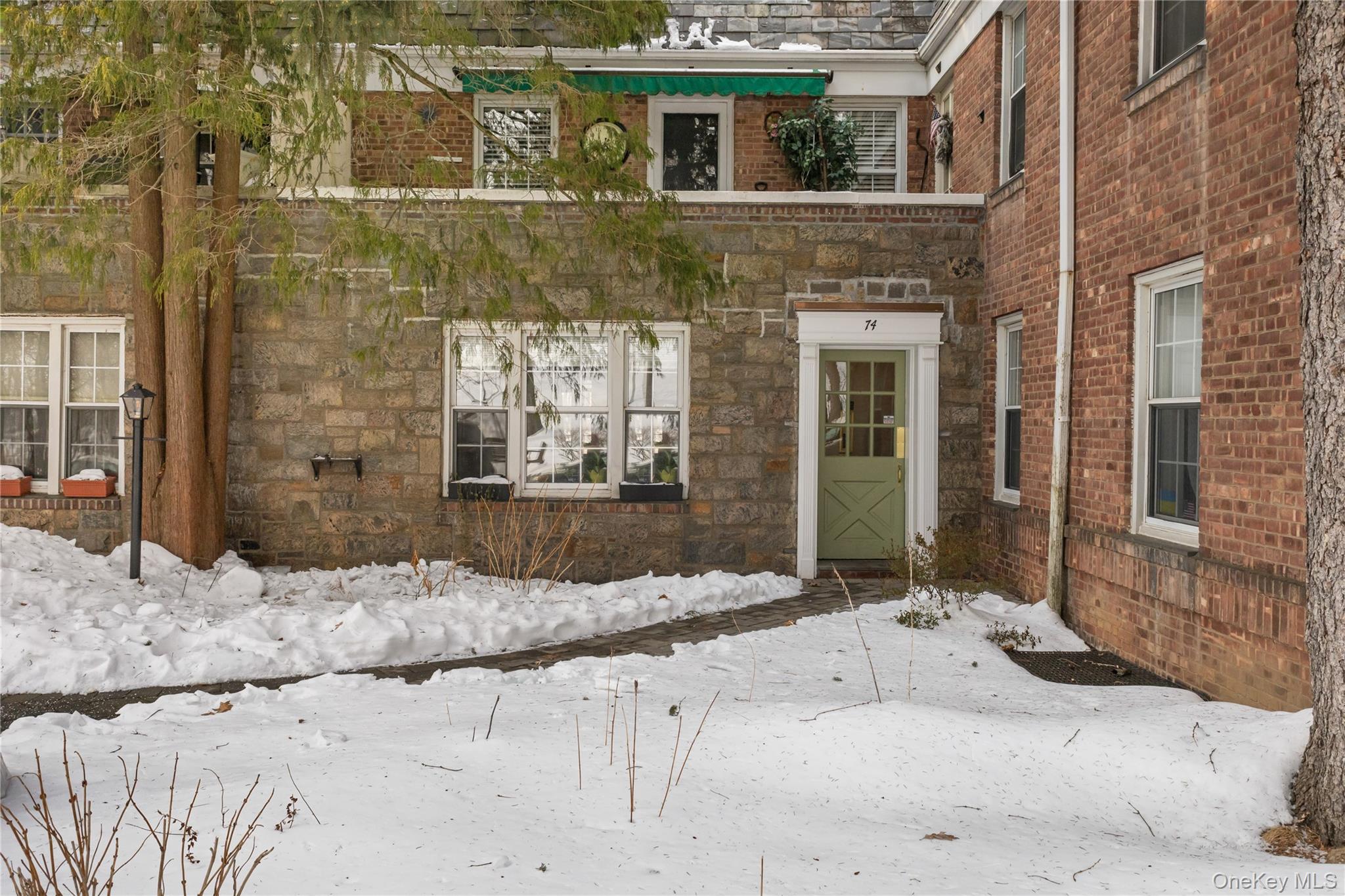 74 Pinewood Road, Unit 2F Hartsdale, NY 10530 - Photo 26 of 29 a view of a brick house with large windows