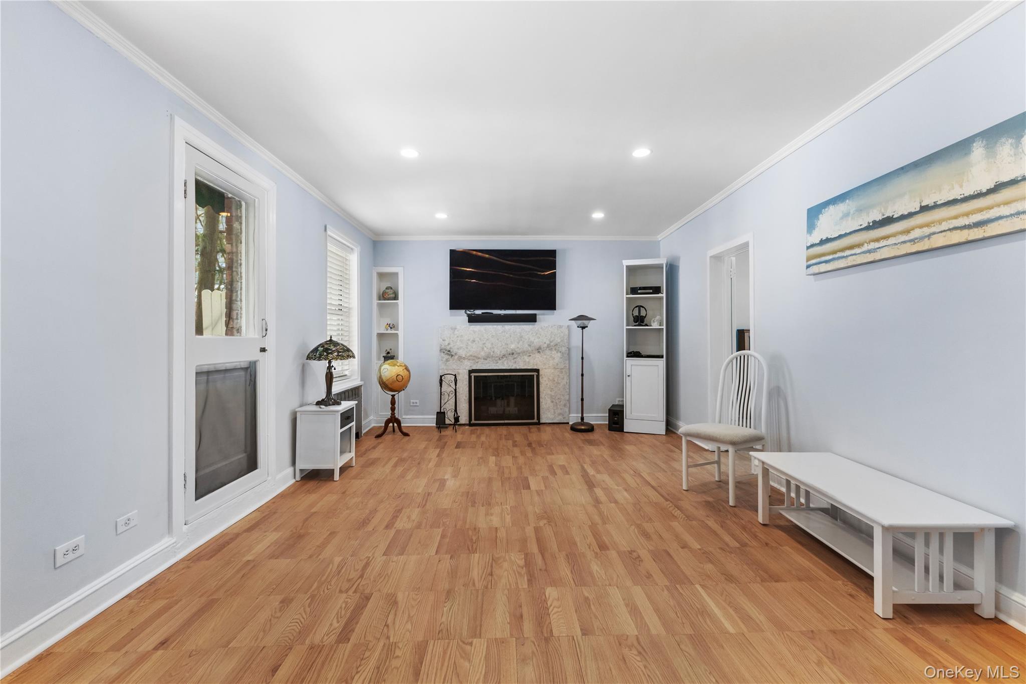 74 Pinewood Road, Unit 2F Hartsdale, NY 10530 - Photo 6 of 29 a view of a livingroom with furniture a fireplace wooden floor and window