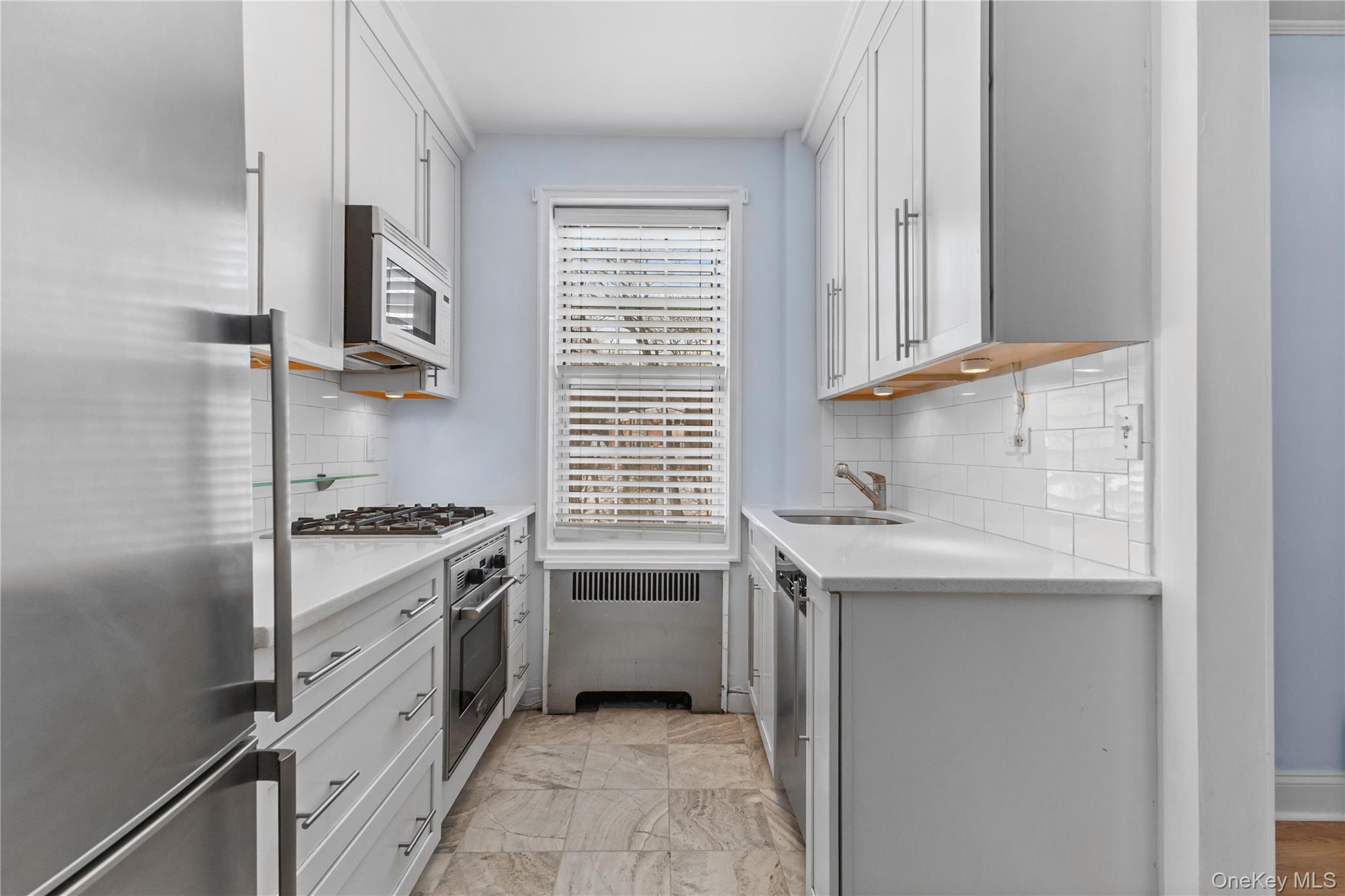 74 Pinewood Road, Unit 2F Hartsdale, NY 10530 - Photo 10 of 29 a kitchen with stainless steel appliances granite countertop a sink and a stove