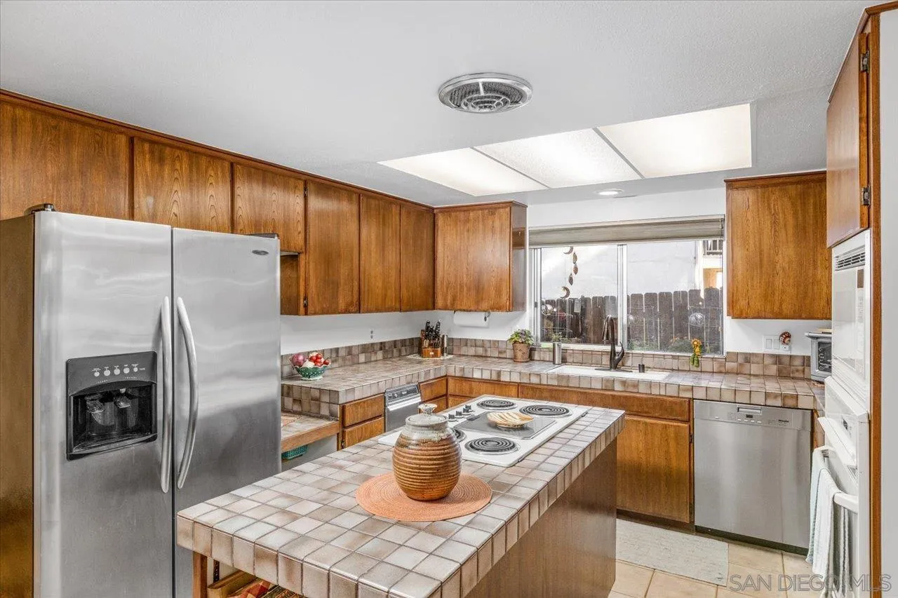 16109 Watt Way Ramona, CA 92065 - Photo 11 of 51 a kitchen with stainless steel appliances granite countertop a sink a stove and a refrigerator