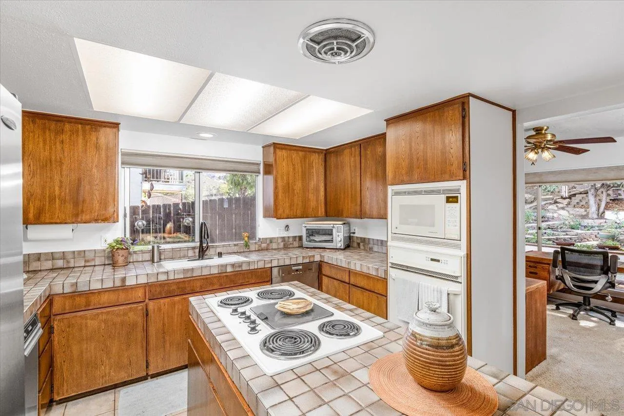 16109 Watt Way Ramona, CA 92065 - Photo 12 of 51 a kitchen with a refrigerator and a sink