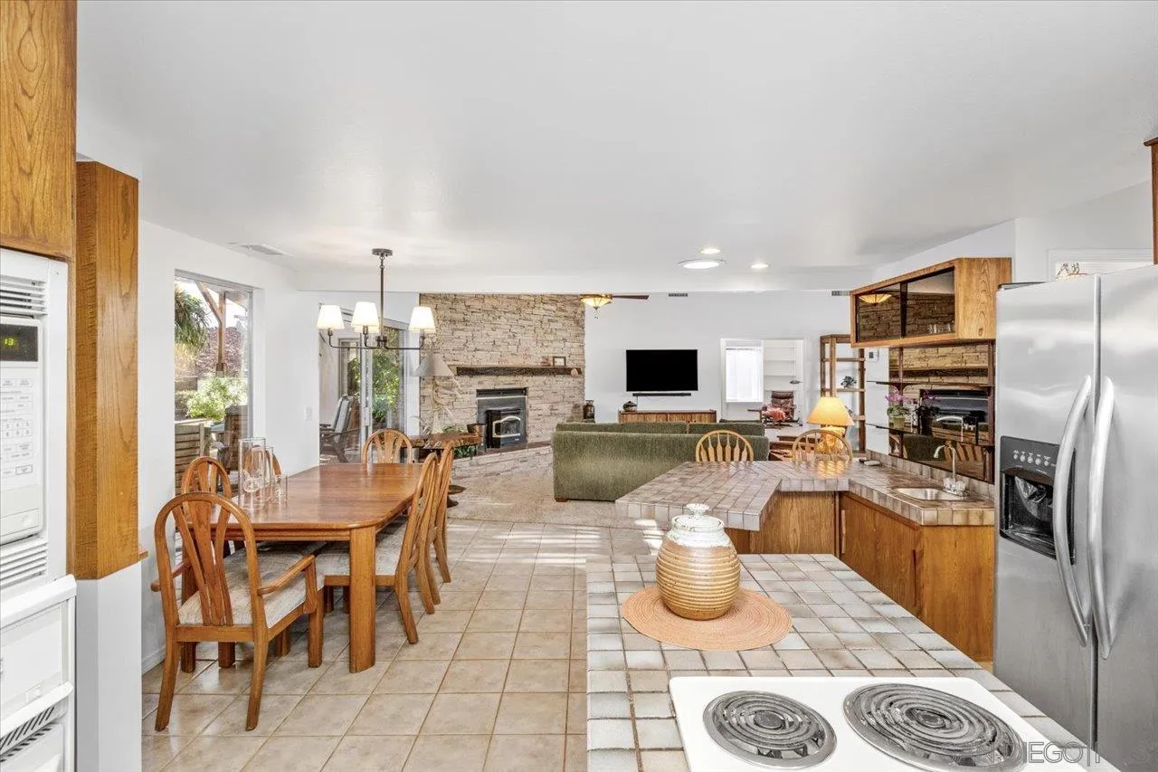 16109 Watt Way Ramona, CA 92065 - Photo 13 of 51 a large kitchen with a table and chairs