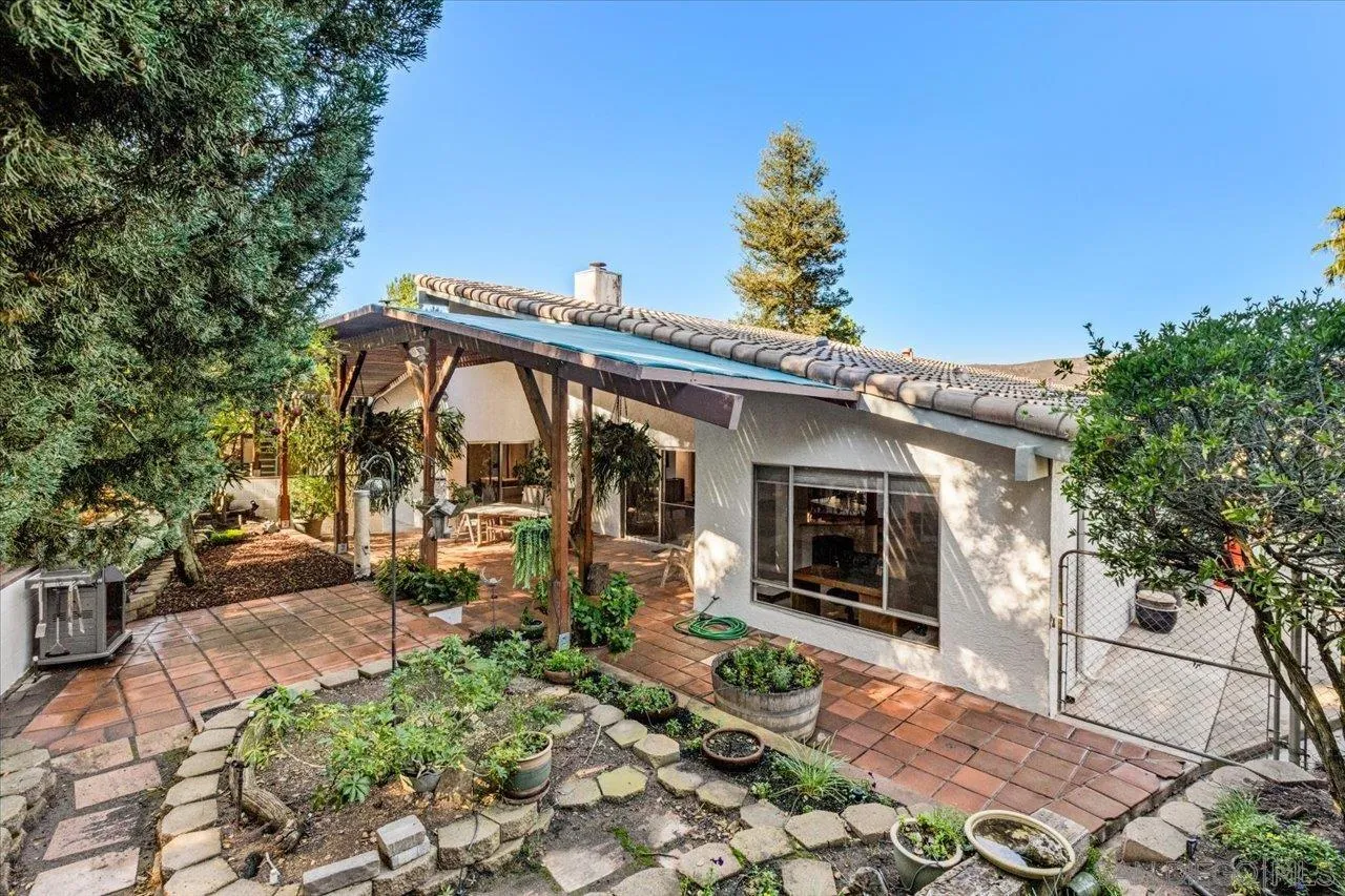 16109 Watt Way Ramona, CA 92065 - Photo 20 of 51 a view of a patio with table and chairs with wooden floor and fence