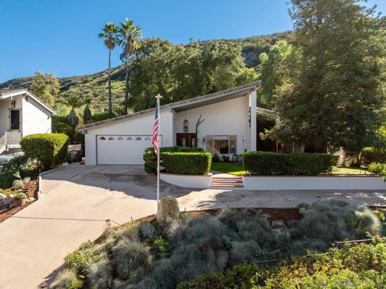 16109 Watt Way Ramona, CA 92065 - Photo 2 of 51 a view of a backyard with plants and a garage