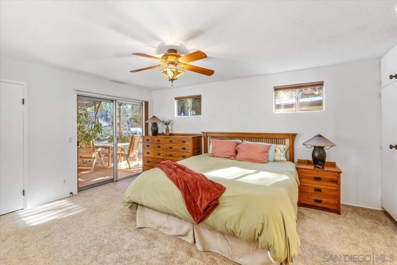 16109 Watt Way Ramona, CA 92065 - Photo 27 of 51 a bedroom with a bed a chandelier and dresser