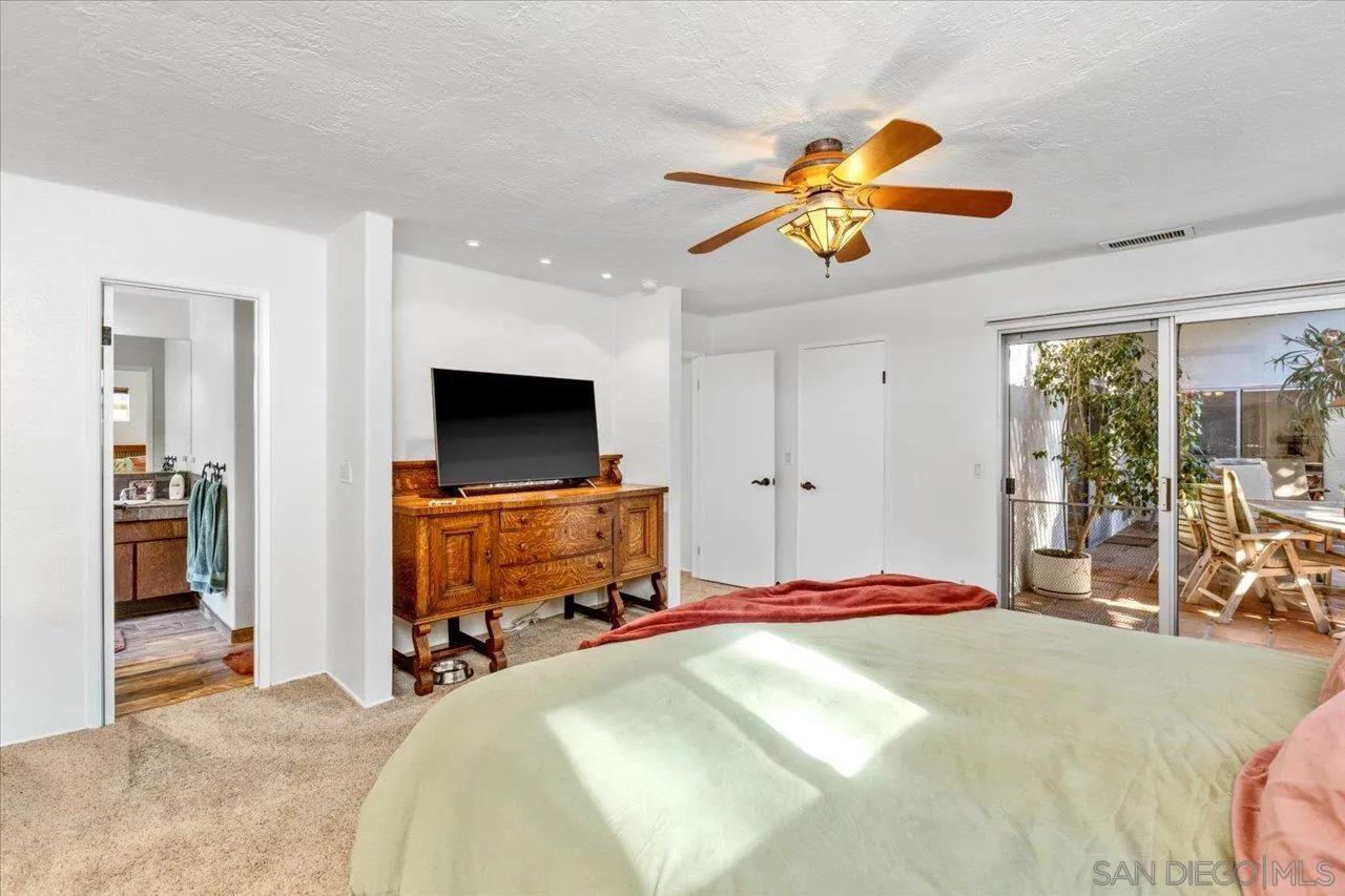 16109 Watt Way Ramona, CA 92065 - Photo 28 of 51 a bedroom with a bed and a flat screen tv