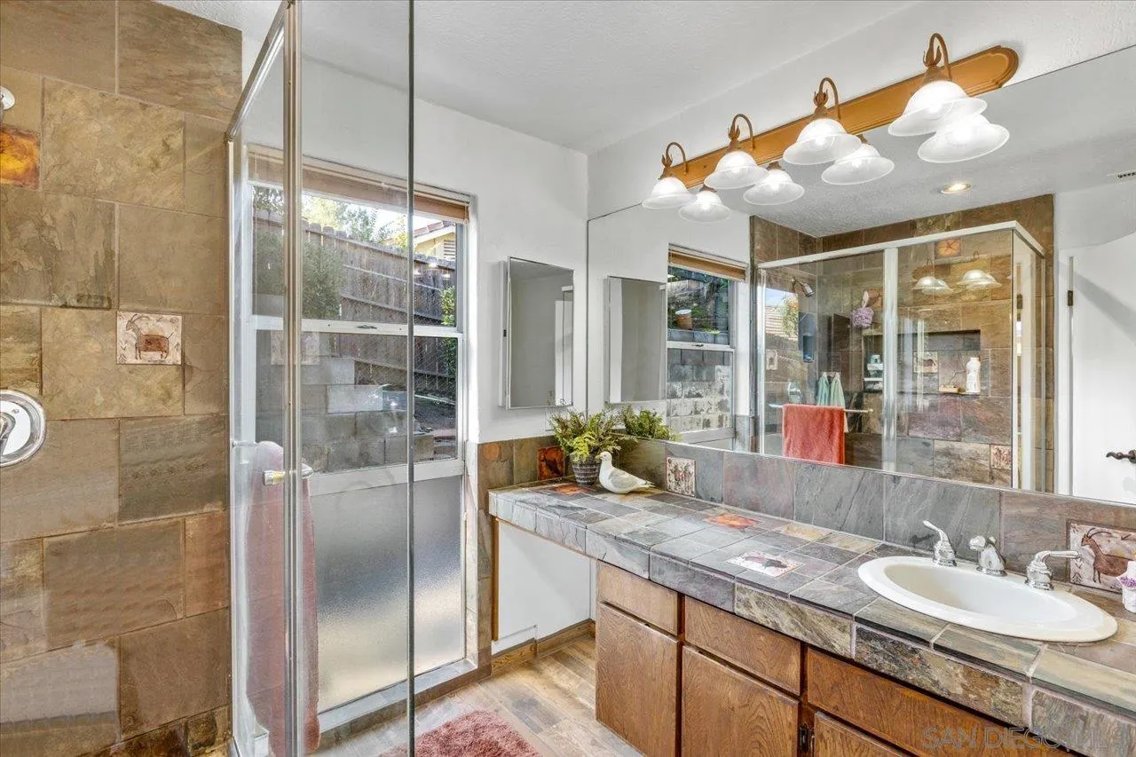 16109 Watt Way Ramona, CA 92065 - Photo 29 of 51 a bathroom with a granite countertop sink and a mirror