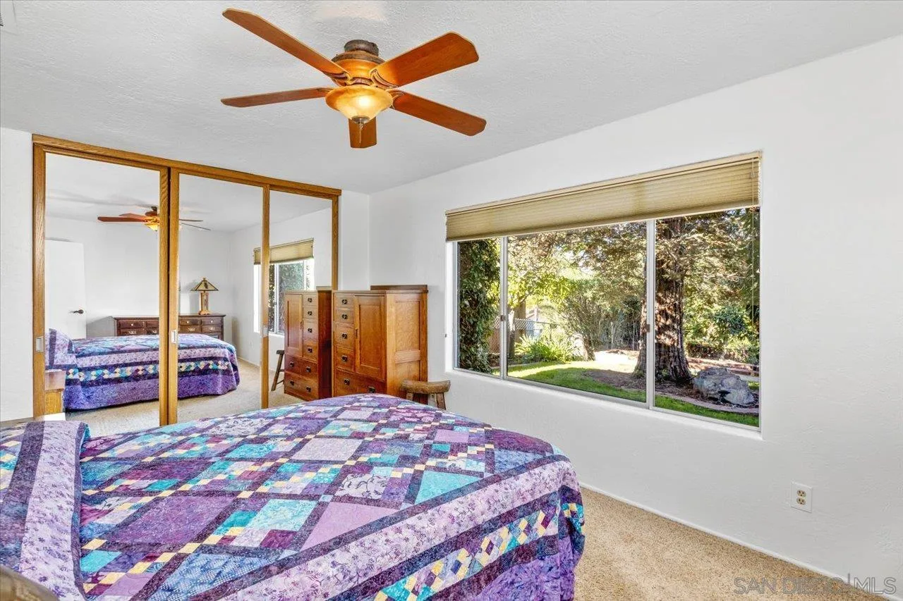 16109 Watt Way Ramona, CA 92065 - Photo 30 of 51 a bedroom with a large bed and a large window