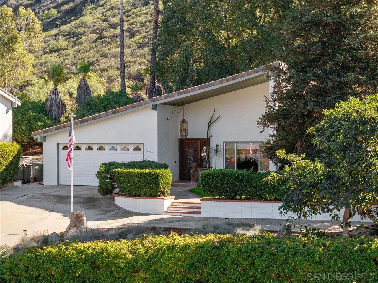 16109 Watt Way Ramona, CA 92065 - Photo 37 of 51 a front view of a house with a yard and garage