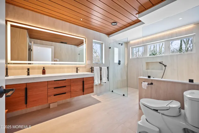 a spacious bathroom with a sink a toilet and a bathtub