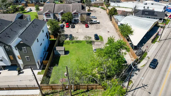 an aerial view of multiple houses with yard