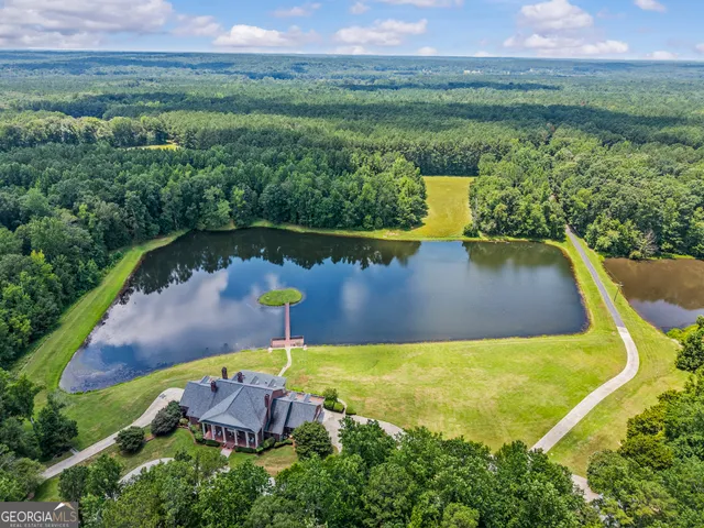 an aerial view of a house with a lake view