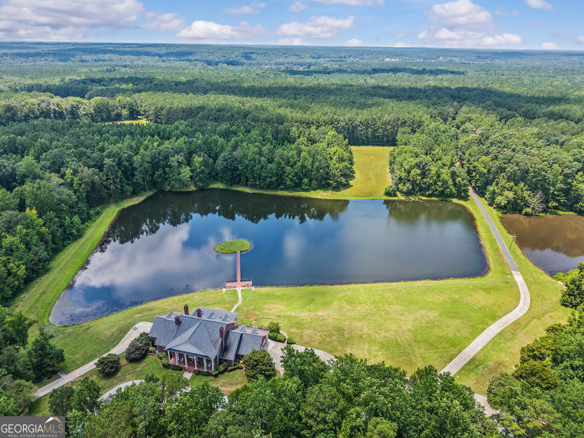 an aerial view of a house with a lake view