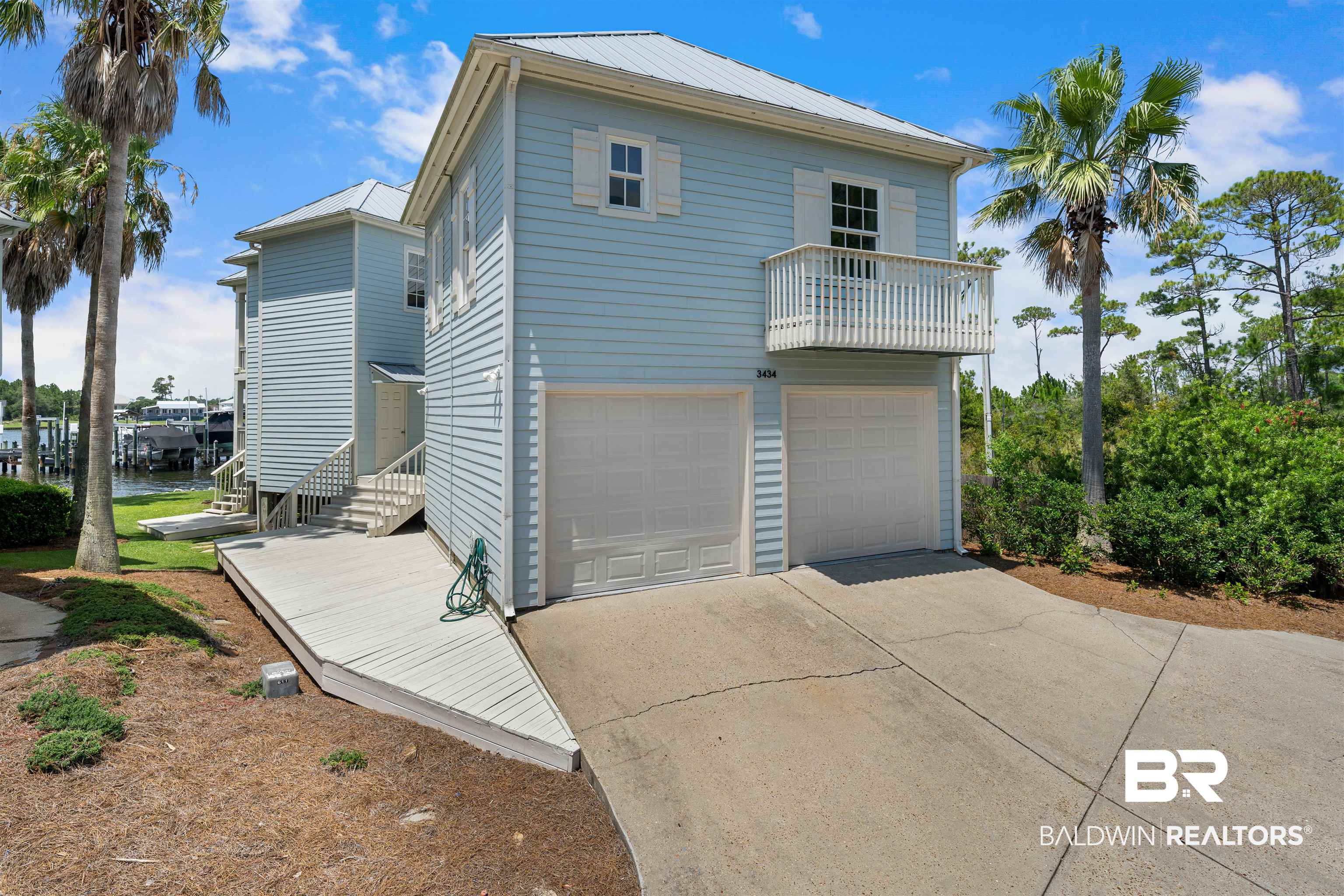 3434 Mariner Circle Orange Beach, AL 36561 - Photo 3 of 38 View of rear of home with a garage and a balcony from one of the guest rooms.
