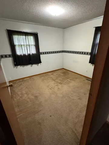 view of an empty room with a window