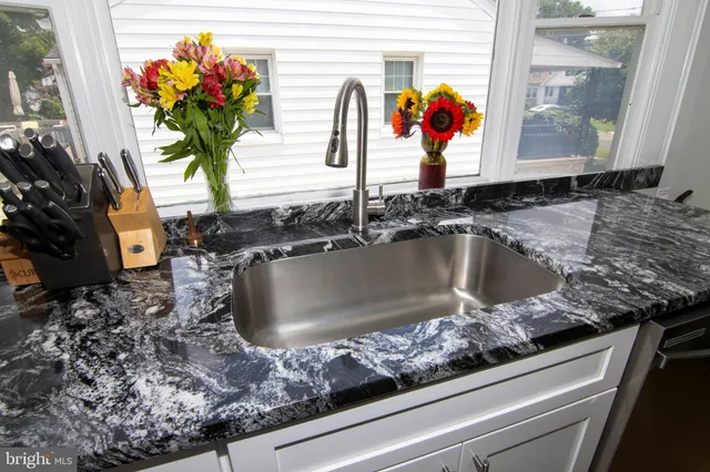 a kitchen with a dining table chairs and refrigerator
