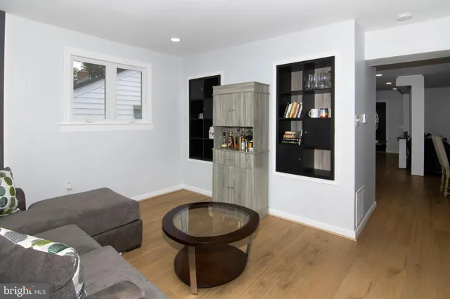 a room with furniture and view of kitchen