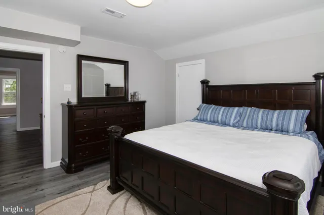 a bedroom with a bed and a dresser