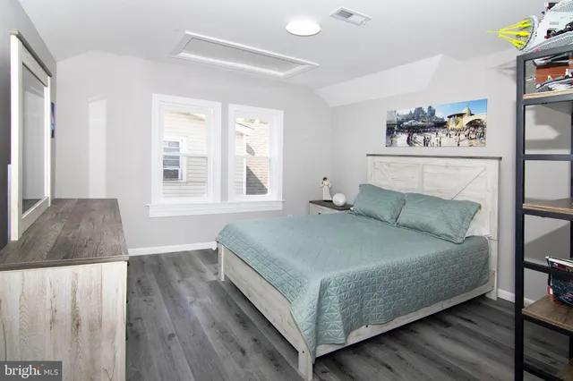 a bedroom with a bed and a bookshelf