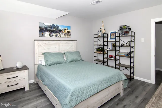 a bed room with a bed and a mirror