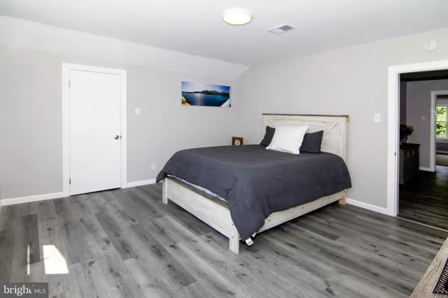 a spacious bedroom with a bed and a window