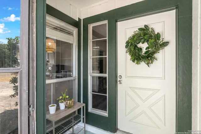 a view of an entryway with wooden floor