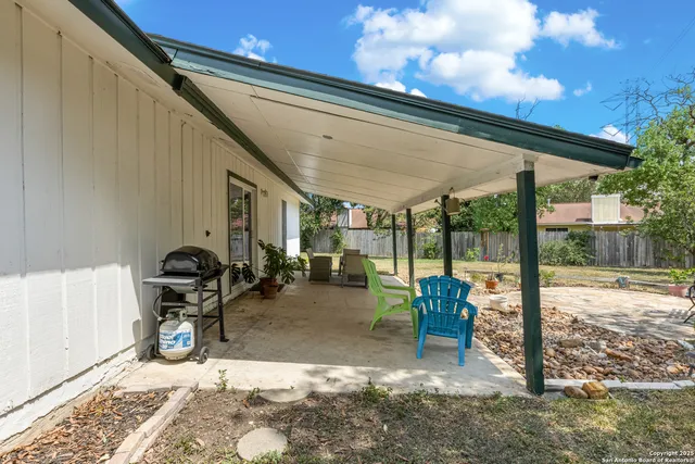 a view of a house with backyard porch and sitting area