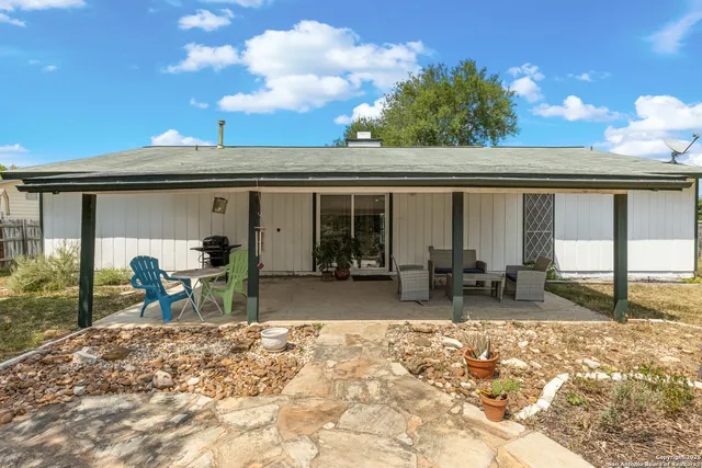 a view of a backyard with wooden fence
