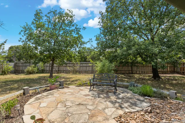 a view of backyard with swimming pool and sitting area