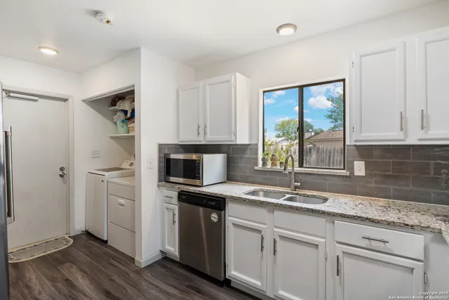 a kitchen with granite countertop a sink and a window