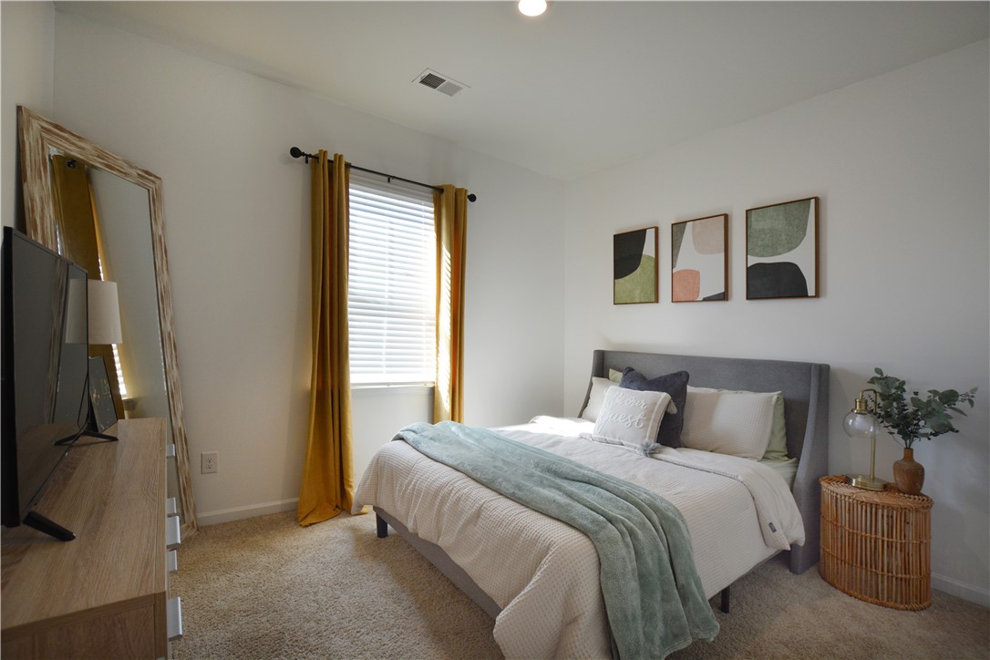 242 Hillendale Way Pelzer, SC 29669 - Photo 5 of 19 This inviting bedroom features soft carpeting, a window for natural light, and ample space.