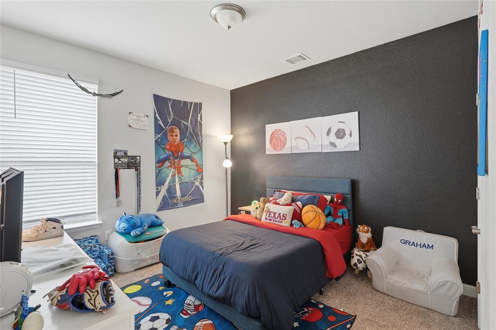 1812 Ruffian Road Granbury, TX 76049 - Photo 22 of 37 Textured accent wall, ceiling-mounted light fixture, white window blinds, wall-to-wall carpeting, and a built-in closet door