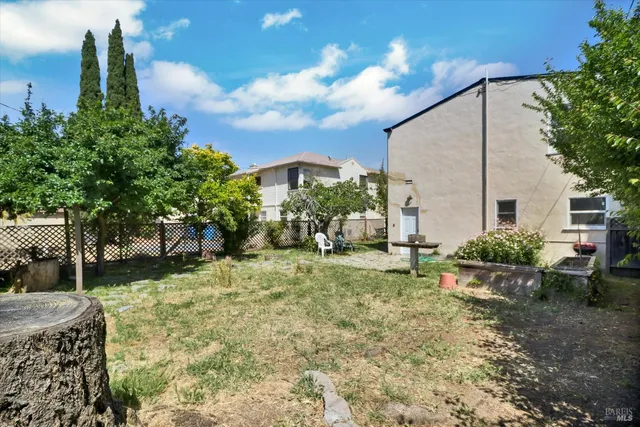 a view of a house with backyard and sitting area