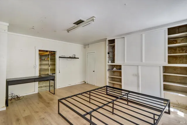 a view of a room with wooden floor and closet