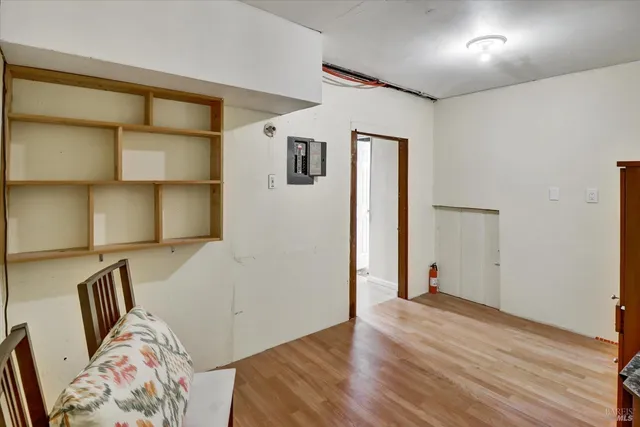a view of a bedroom with wooden floor and closet