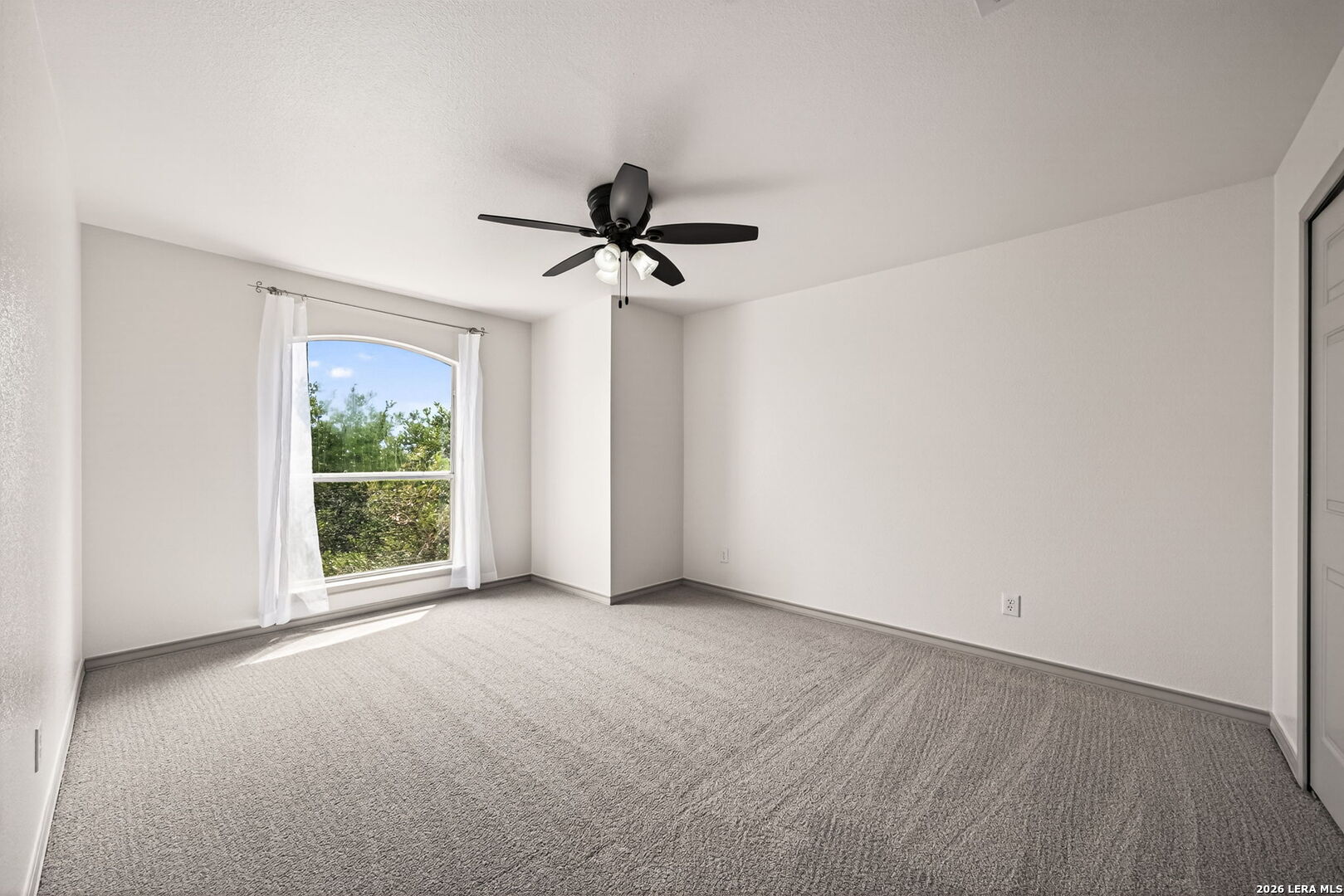 17431 Helotes Spring Road Helotes, TX 78023 - Photo 28 of 50 a view of a livingroom with a ceiling fan and window