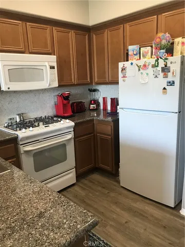 a stove top oven sitting inside of a kitchen