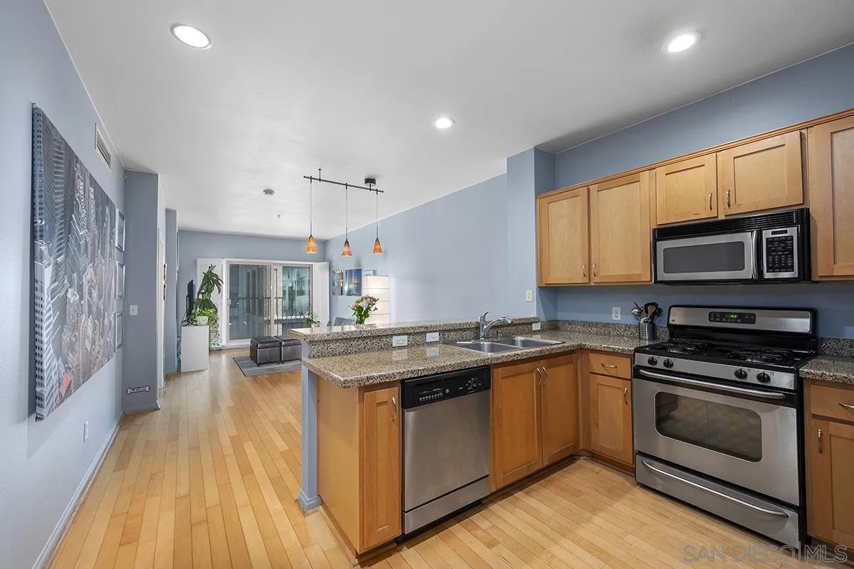 450 J Street, Unit 7071 San Diego, CA 92101 - Photo 12 of 33 a kitchen with stainless steel appliances granite countertop a stove and a sink
