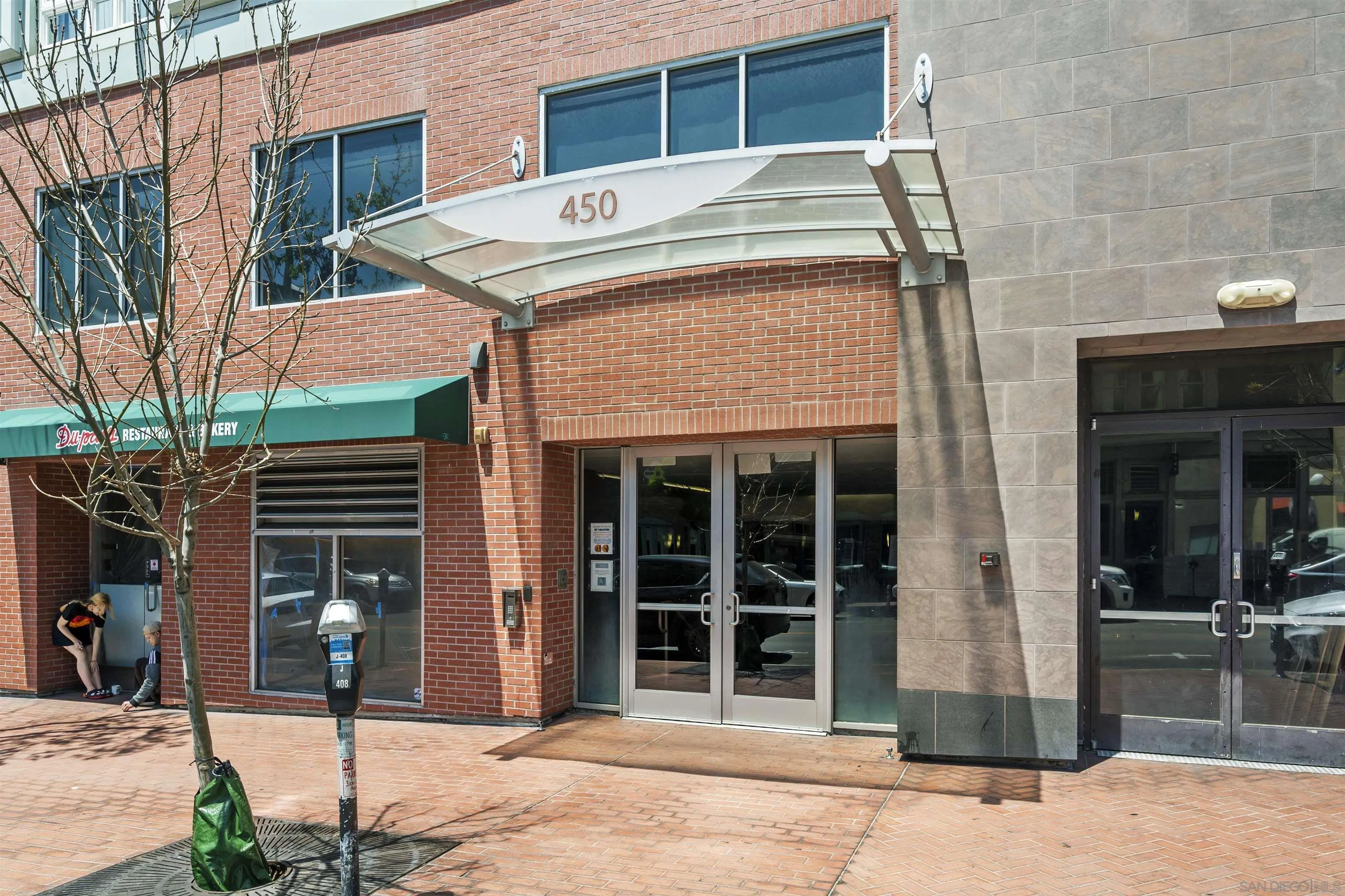 450 J Street, Unit 7071 San Diego, CA 92101 - Photo 23 of 33 a front view of a building with glass windows