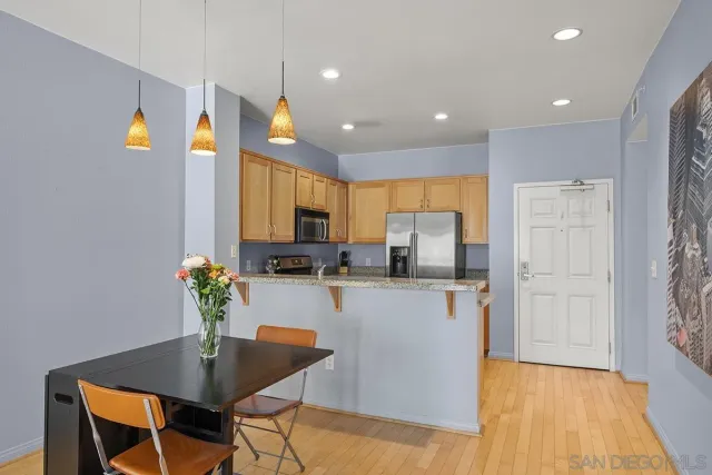 a kitchen with granite countertop a refrigerator and a sink