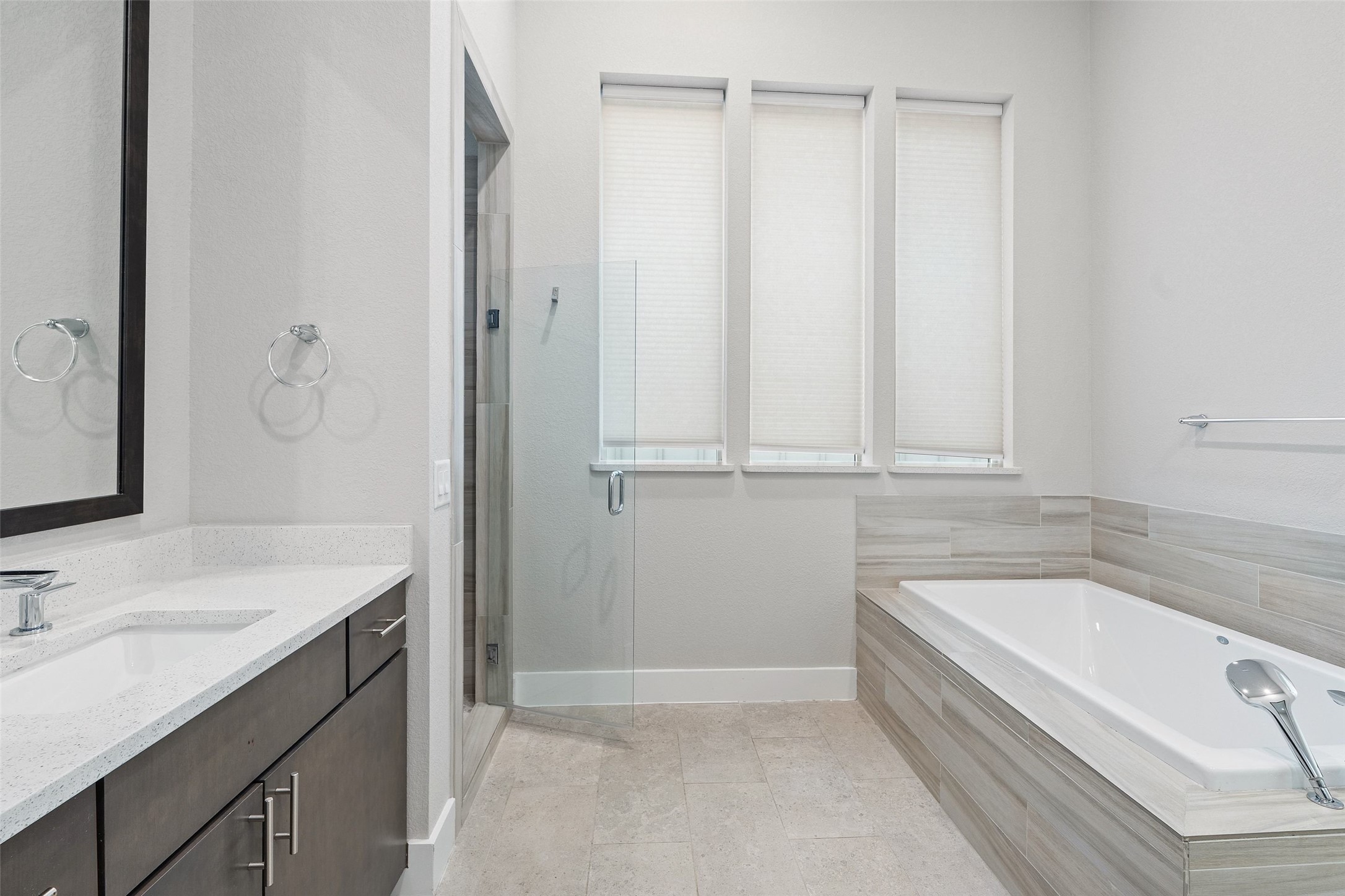 6104 Florencia Lane Austin, TX 78724 - Photo 11 of 31 Bathroom with vanity, a stall shower, a bath, and light tile patterned flooring