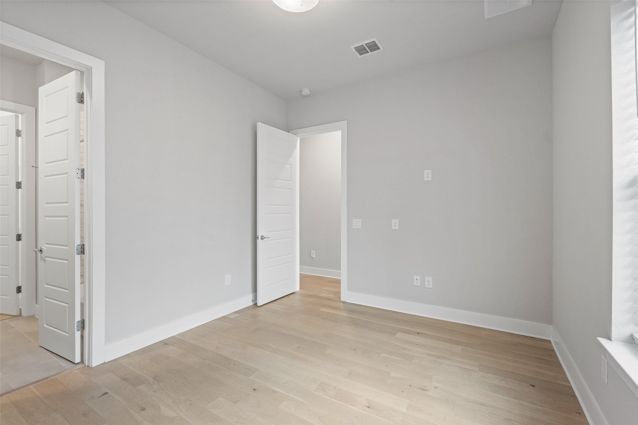 6104 Florencia Lane Austin, TX 78724 - Photo 15 of 31 Unfurnished bedroom featuring light wood-style floors and baseboards