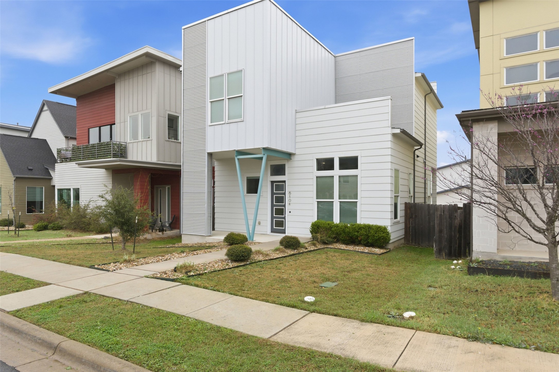 6104 Florencia Lane Austin, TX 78724 - Photo 2 of 31 Contemporary house featuring board and batten siding and a balcony