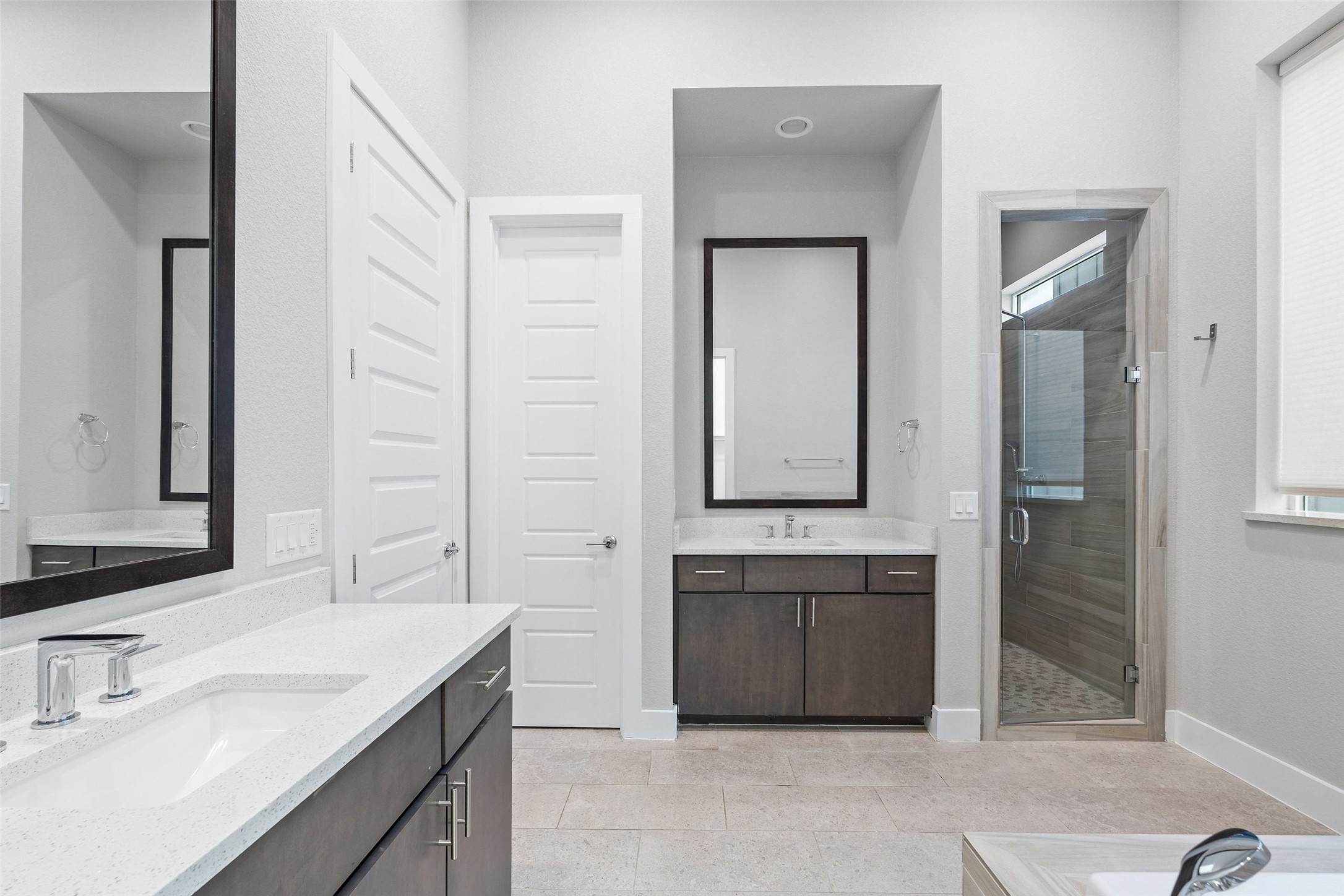 6104 Florencia Lane Austin, TX 78724 - Photo 25 of 31 Bathroom with a shower stall, two vanities, light tile patterned floors, and a bath