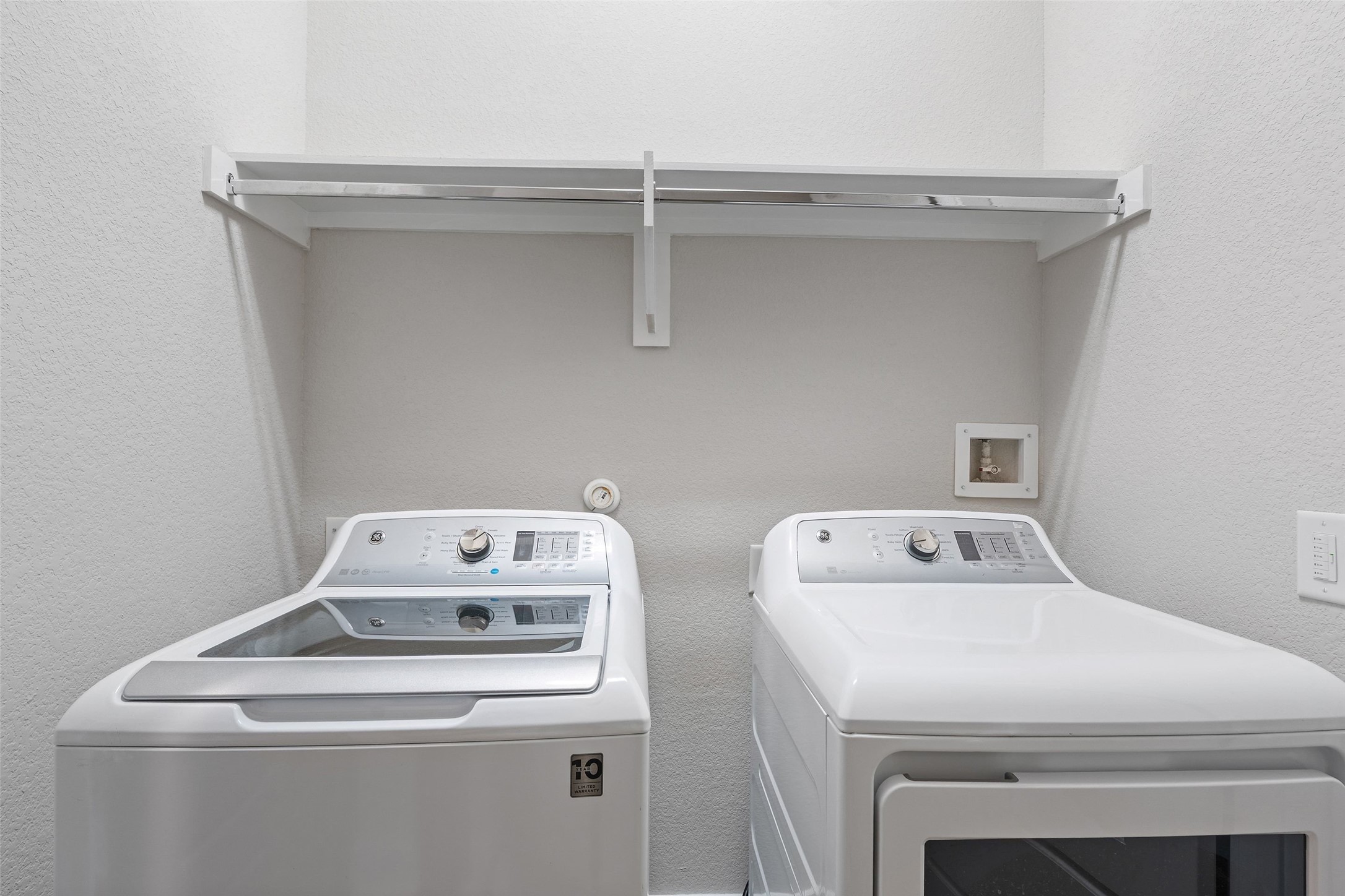 6104 Florencia Lane Austin, TX 78724 - Photo 26 of 31 Laundry area with a textured wall and washer and dryer