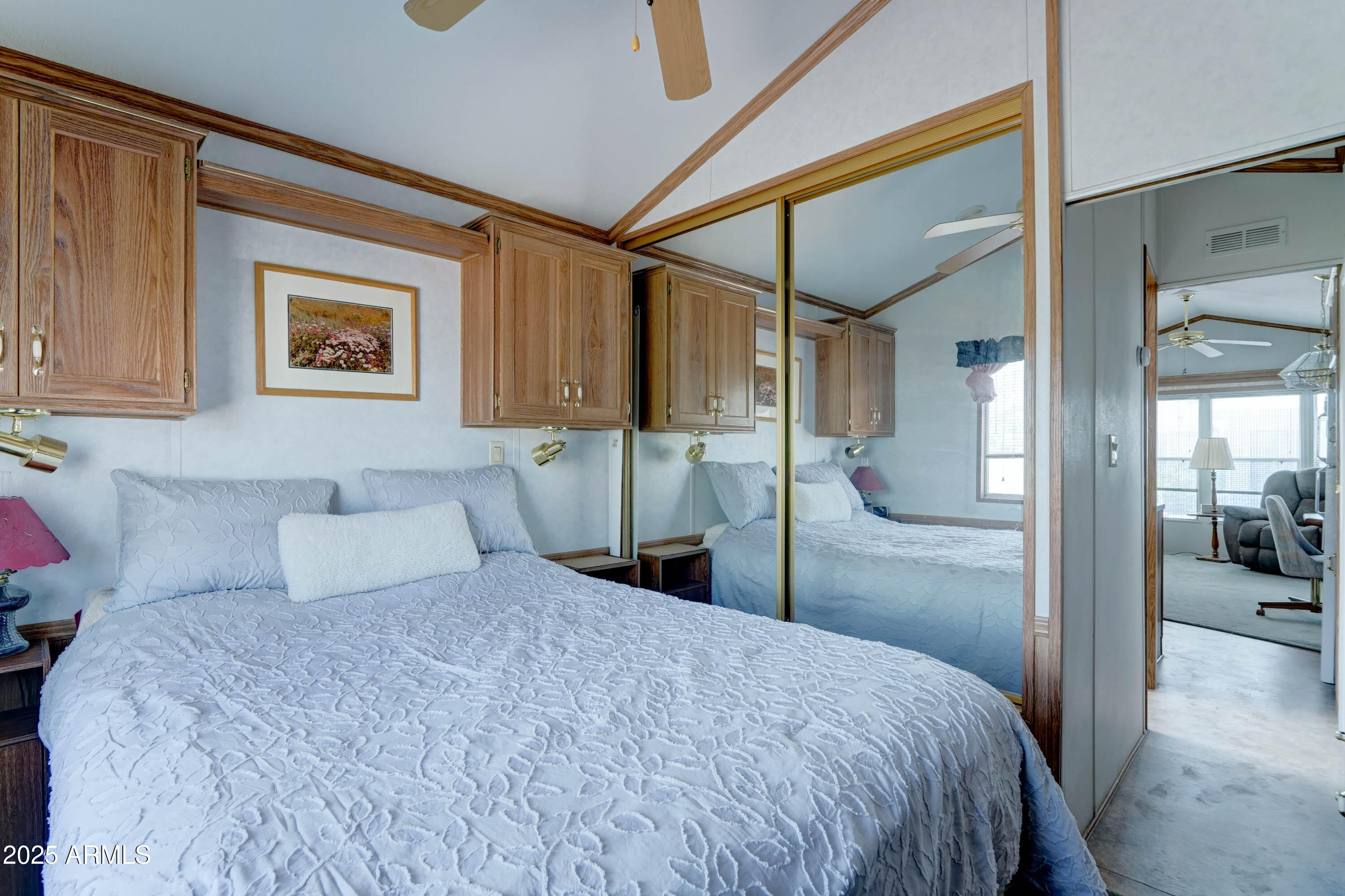 111 South Greenfield Road, Unit 822 Mesa, AZ 85206 - Photo 13 of 25 a bedroom with a large bed and a painting on the wall